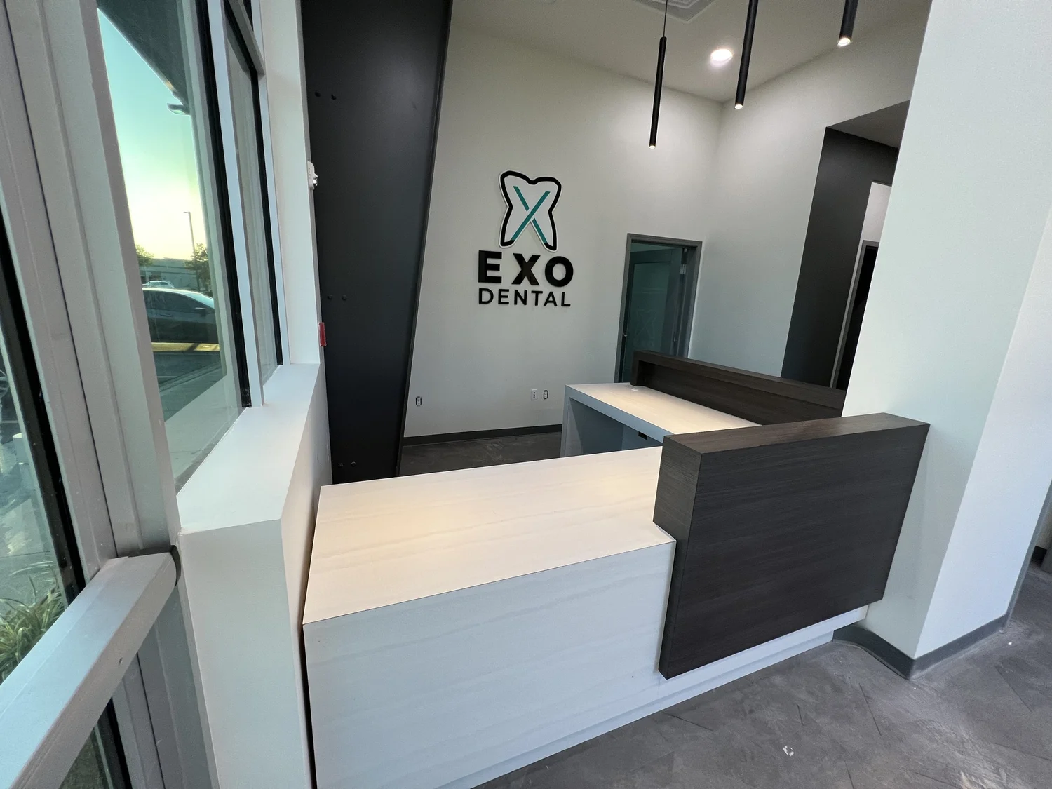 Modern two-tone custom reception desk at EXO Dental