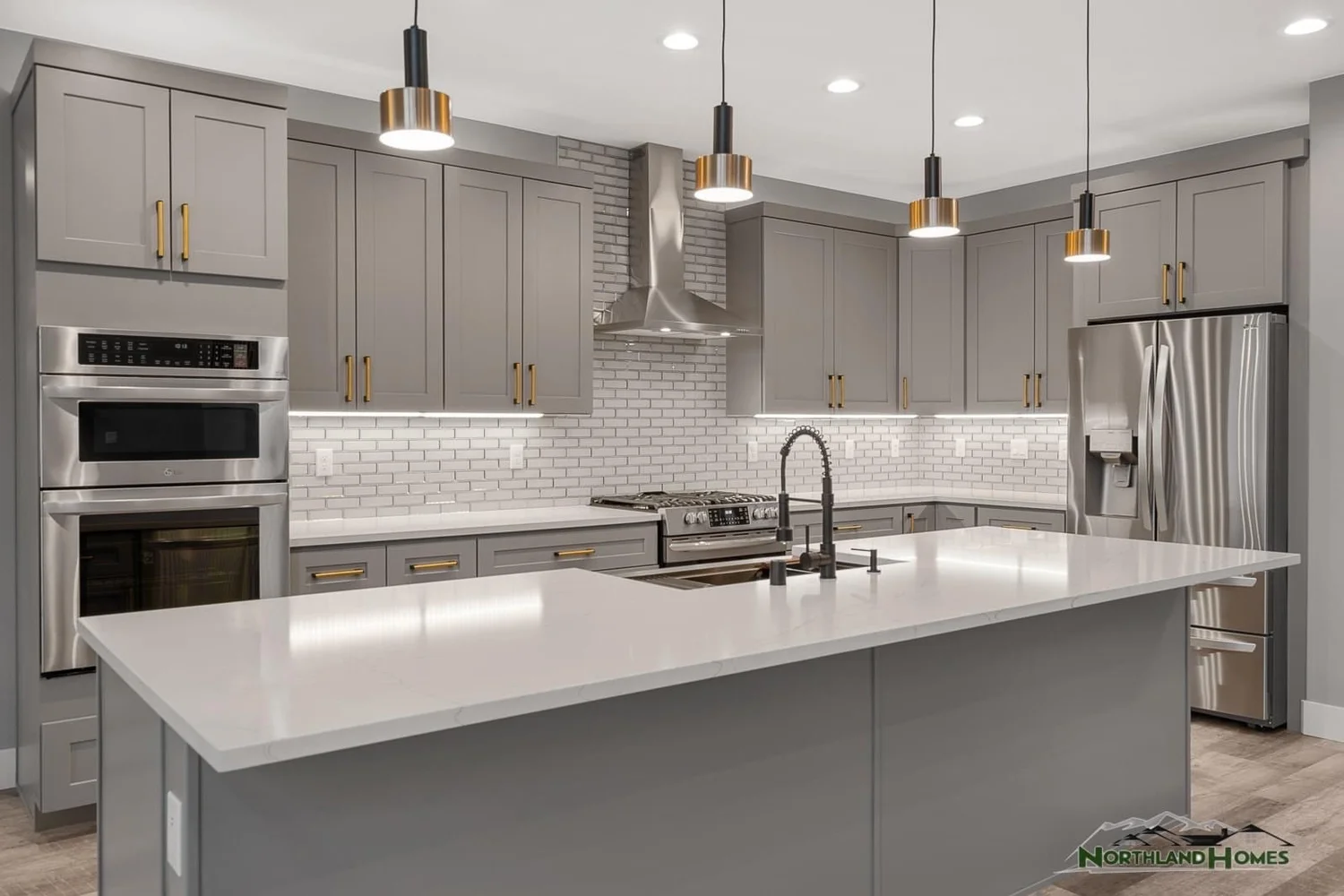 Modern gray shaker kitchen with brass pulls