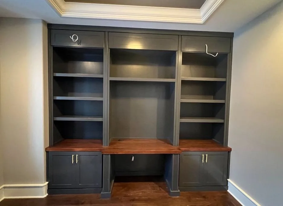 Charcoal gray built-in office with wood desktop