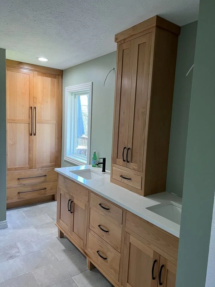 Natural wood double bathroom vanity and tall storage cabinets